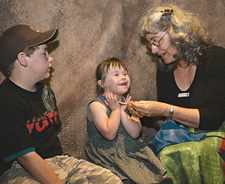 Storyteller Rose Costelloe entertaining young Museum visitors Darcy and Neave.