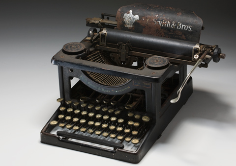 Black painted steel-framed typewriter with circular keys