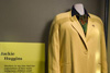 A display showcasing a yellow outfit worn by Jackie Huggins