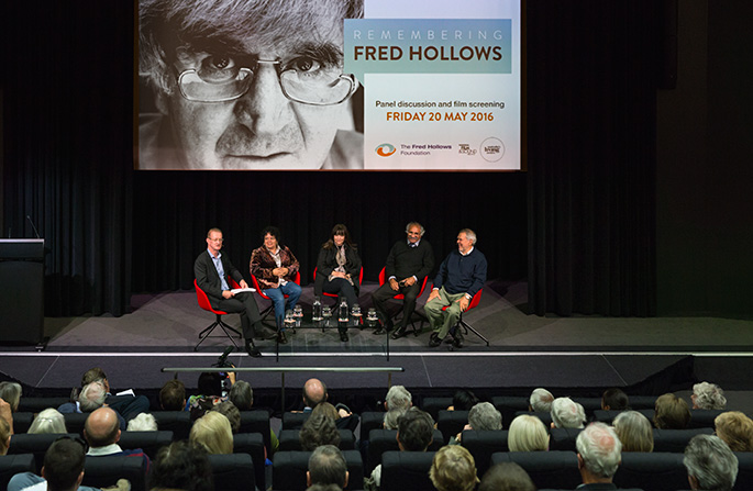 A group of people on stage in front of an audience.