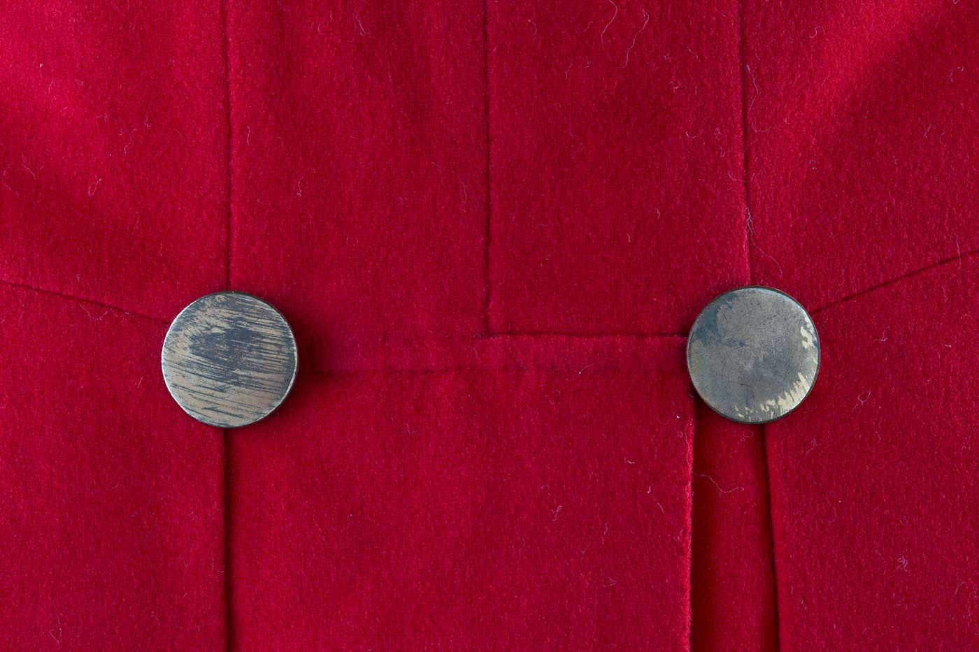 Details of buttons on a red coat. - click to view larger image