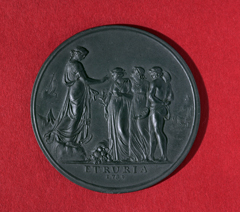 Dark grey circular medallion with four classical figures in relief, above 'ETRURIA, 1789'.