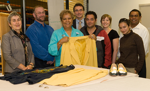 Museum staff and Jackie Huggins with her jacket, blouse, shoes and earrings.