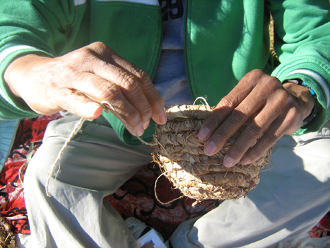 Woman weaving a basket