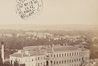 Free education introduced sepia-toned photograph of a large three-storey white building