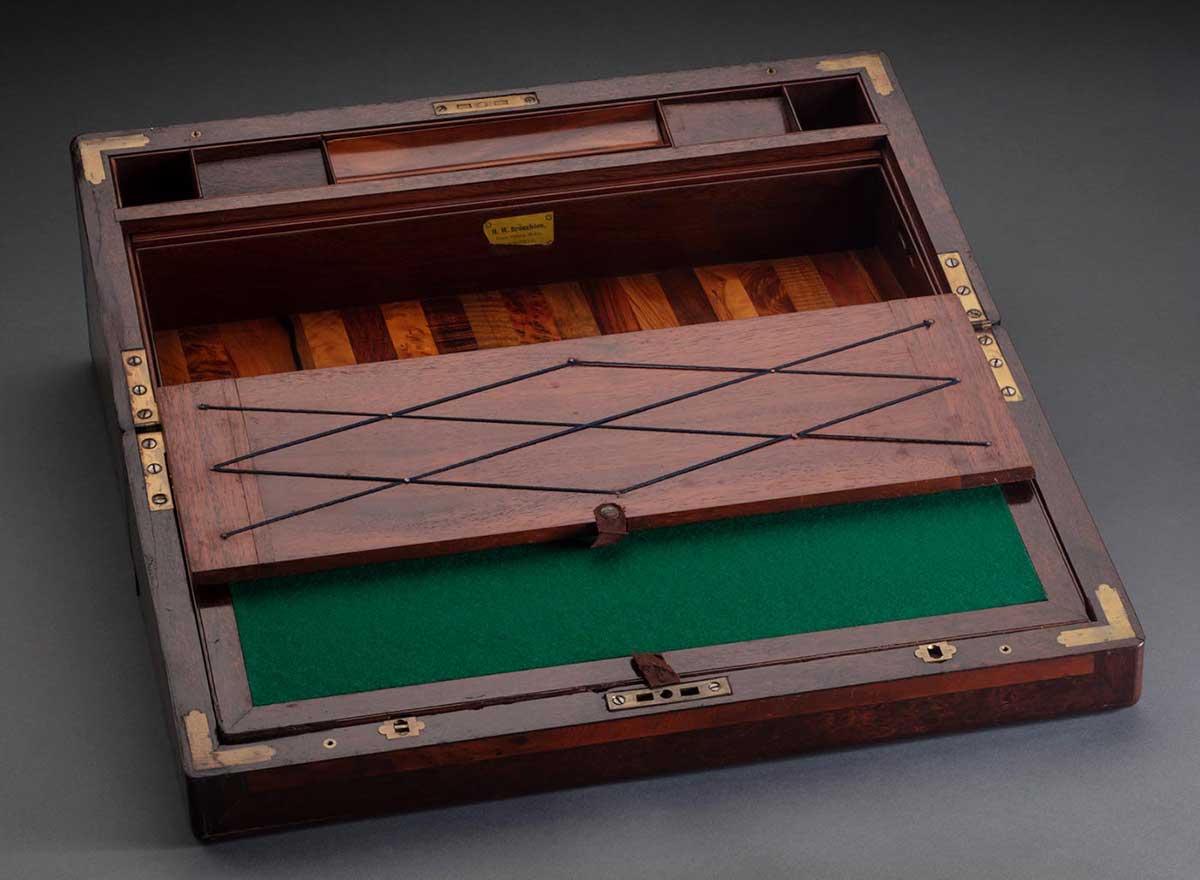 A writing desk made from different woods displaying compartments. - click to view larger image