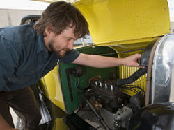 Conservator Ainslie Greiner looks under the Citroen's engine cover.