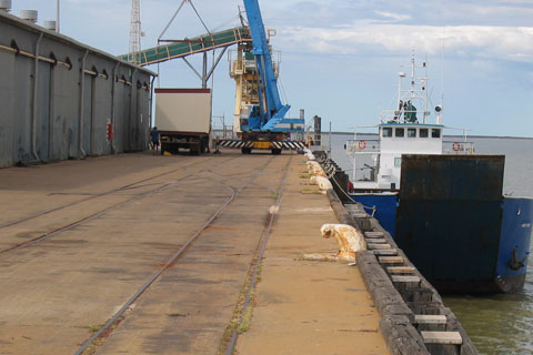 Derby jetty, with a ship docked at right and machinery on the jetty at left