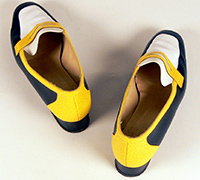 Pair of navy, yellow and white shoes belonging to Jackie Huggins.