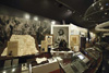 A display featuring the National Museum's Tooloyn Koortakay collection including pastel drawings, lino cuts, possum skin dance ornaments, a selection of tools, and possum skin cloaks