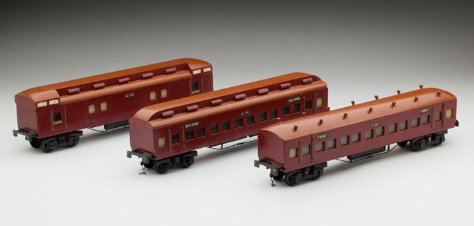 (l-r) Victorian Railways CW guard’s van, second class and first class passenger cars, made from wood with lead composition and diecast wheels by John May and Alan Budge