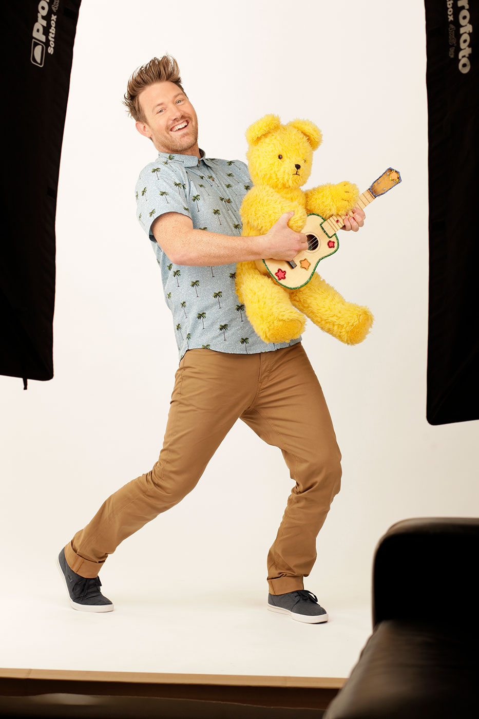Eddie Perfect holding Big Ted who is holding a toy guitar.
