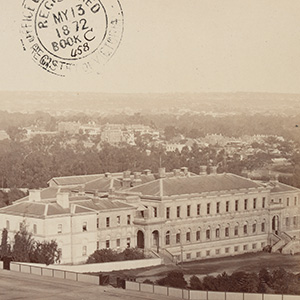 sepia-toned photograph of a large three-storey white building
