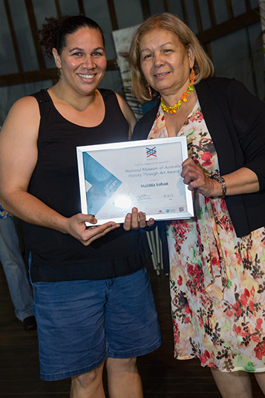 Two women with a certificate award