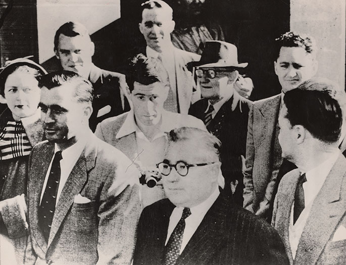 Photo showing mainly men in suits.