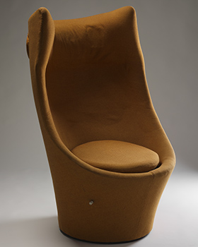 Upholstered orange chair with a circular base and cushion. The high back includes speakers in the winged headrest.