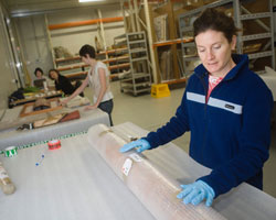 Tracey Langner with cylinder wrapped in bubble-wrap.