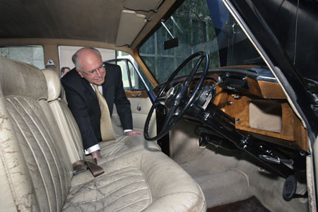 John Howard peers into the front of the Bentley to inspect its seats, steering wheel and dash.