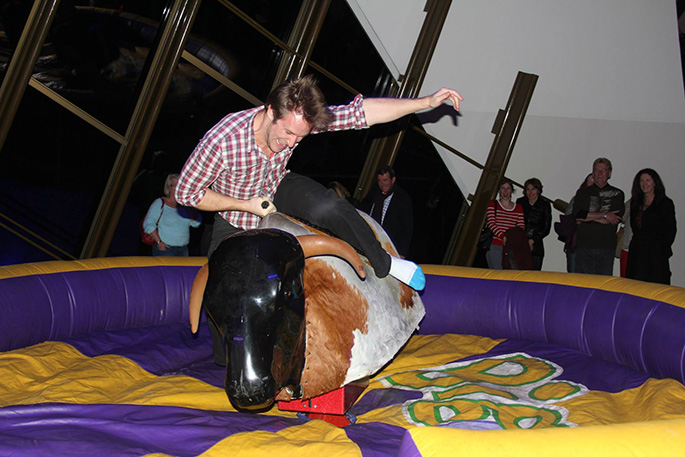 A man riding a mechanical bull.