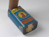 A blue tin with 'DANTE' written at the top and 'MINERVA SA' at the base. An image of a man dressed in red appears in a central circle on the tin. Bamboo tubing extends from one end.
