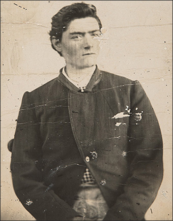 Photo of a young man taken from waist up.