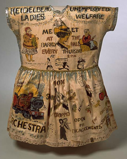 Girl's fancy dress garment, hand-painted with cartoons and caricatures showing the work of the Heidelberg Unemployment Bureau.
