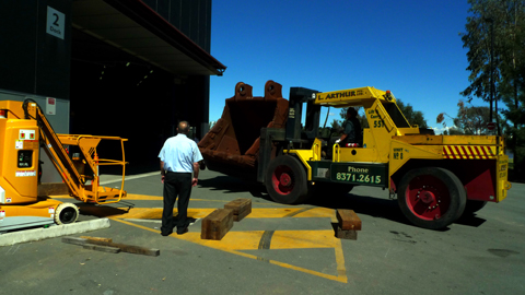 The rock bucket being carried by forklift into the loading bay.