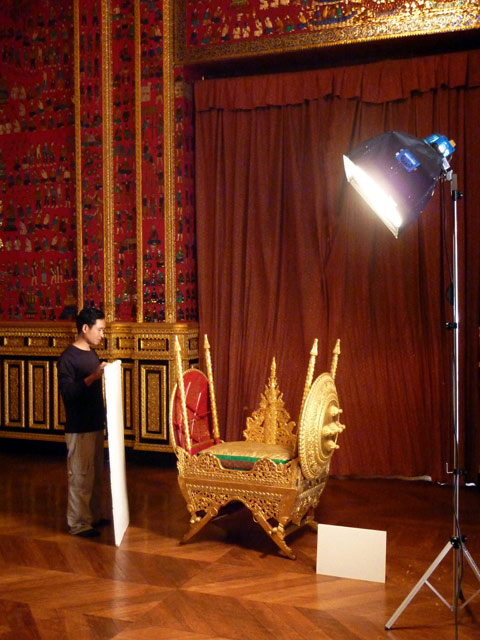 Mr Nouphanh Keosouda, Research and Exhibitions, positions a reflector board prior to the photography of the 'houdah', King's elephant seat.