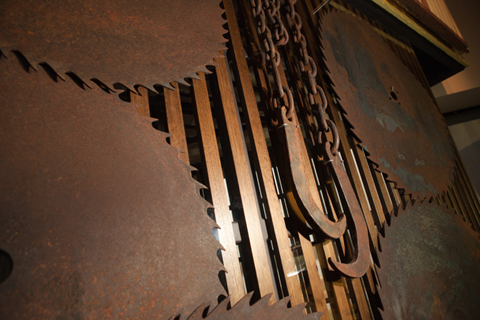 A colour photograph of a circular saw blade installation on a wall.