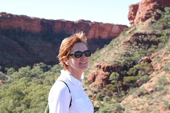 a colour photo of a woman visiting a National Park