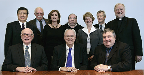 Group photograph of ten members of the Council of the National Museum of Australia. John Hirst, Tony Staley and Craddock Morton are seated at a table and the other seven members are standing behind them.