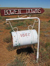 A roadside mailbox. The number on the box is 1862 and the sign above reads 'Bowen Downs'