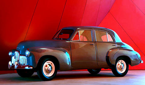 Essington Lewis Holden motorcar. Four door, medium grey sedan with chrome-plated radiator grille.