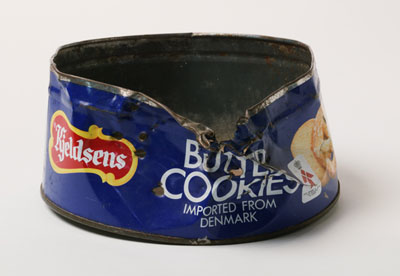 Round 'Butter Cookies' biscuit tin with damage to rim and side.