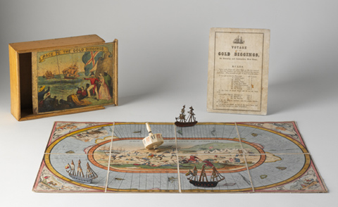 A hand-coloured lithographic playing board made of eight paper sections mounted on linen, with a polygonal twelve-sided teetotum or spinning dice and three small painted metal playing pieces in the shape of tall ships. A varnished wooden box and a instruction sheet have been placed beside the game board.