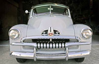A light grey FJ Holden car from the 1950s