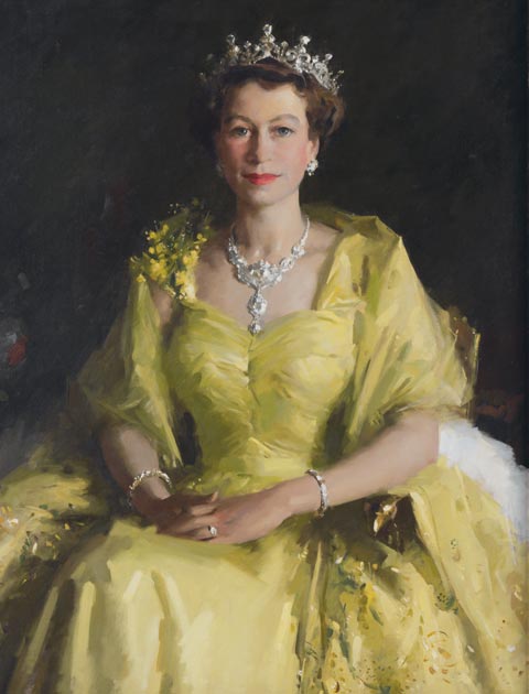 Portrait of Queen Elizabeth II, seated, and wearing a gold-coloured dress. Her hands and folded on her lap and she also wears a tiara, necklace and bracelets.