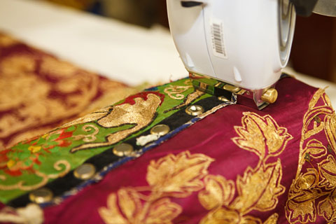 Other areas of testing included the detailed mirror surrounds, embroidered on the costume. The surface of the costume is in contact with the XRF apparatus to ensure accurate readings.