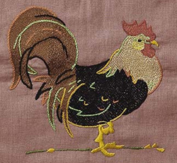 Close up quilt detail of a rooster embroidered in one of the squares.