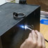 The locksmith inserts a blank key in order to gain an impression of the cut of the lock.