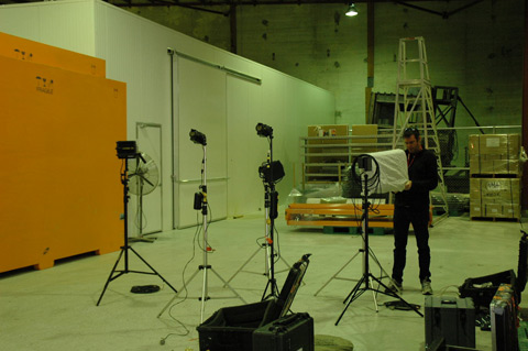 The crew commence setting up the lights.