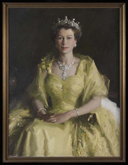 Framed portrait of Queen Elizabeth II, seated, and wearing a gold-coloured dress. Her hands and folded on her lap and she also wears a tiara, necklace and bracelets.