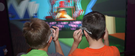 Back view of two boys wearing 3D glasses.