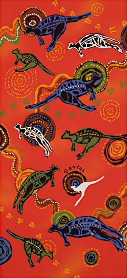 The design features several X-ray style kangaroos in green, blue and black, in various orientations, and concentric circles. The background is bright mottled orange. There is also a grey Qantas logo kangaroo just below the centre.