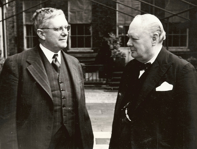 Evatt and Churchill stand next to each other looking at each other