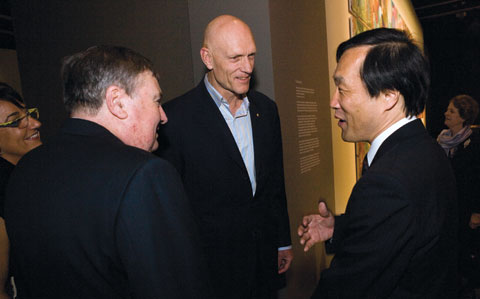 Craddock Morton, Margo Neale and Peter Garrett meet Hideki Hayashida. A large work of art is partially visible in the background.