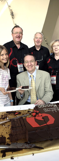 From left: Student Charlotte Thompson with Brian Buckley, David Arnold (seated), Ron Kerr and Stella Smith gathered around a chocolate cake.