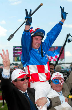 After his third Melbourne Cup win on Makybe Diva, jockey Glen Boss is held aloft by the horse’s owner Tony Santic (right) and trainer Lee Freedman.