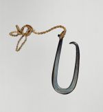 Fishhook made of a large dark purple pinna shell where strings made of various plant fibres are attached.