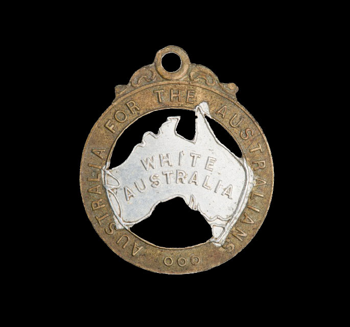 this 28mm-high badge has the words ‘Australia for the Australians’ stamped on the rim and the words ‘White Australia’ stamped on silver-painted representation of the Australian continent in the middle.